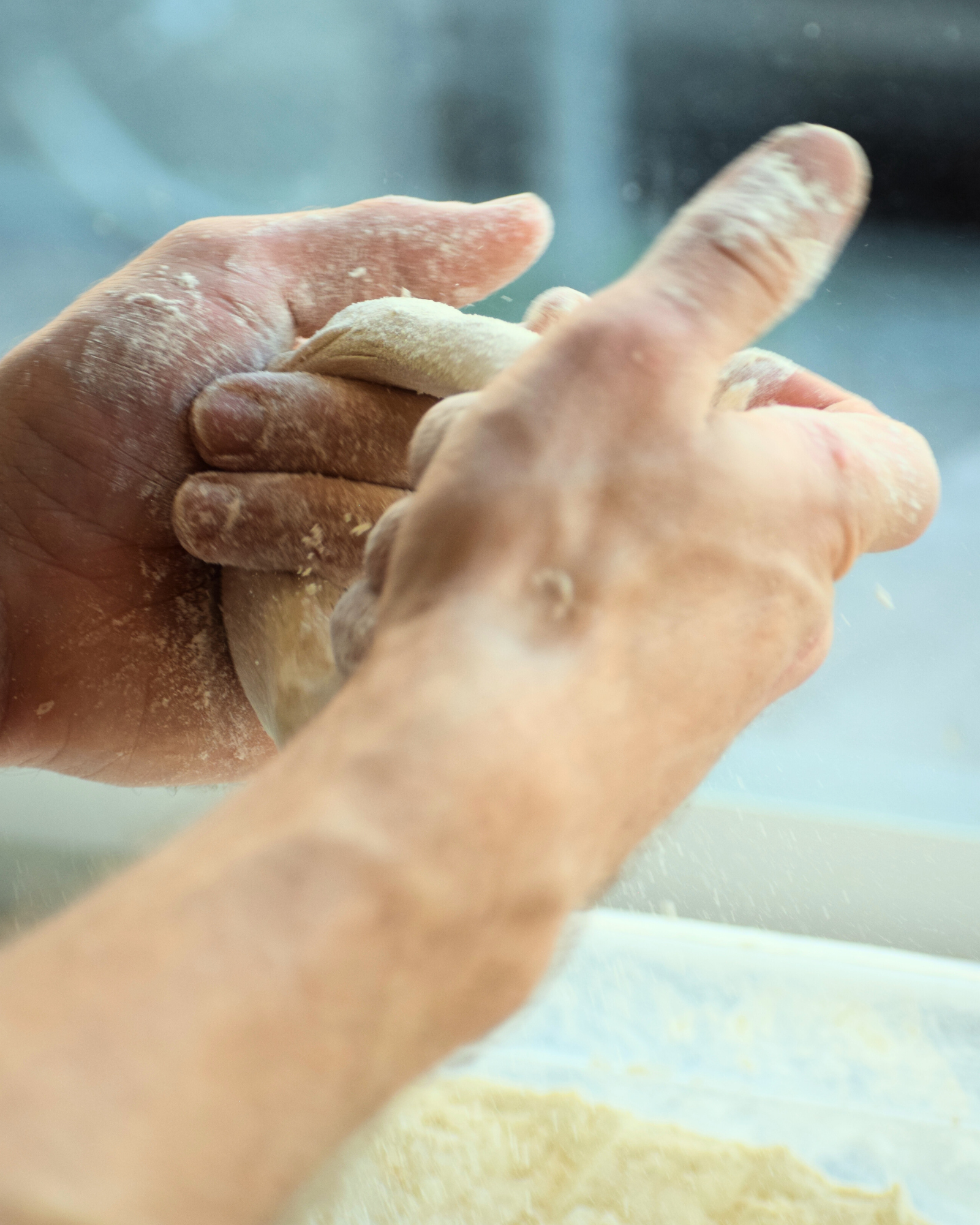 Fresh HALO bagel being dipped in sauce
